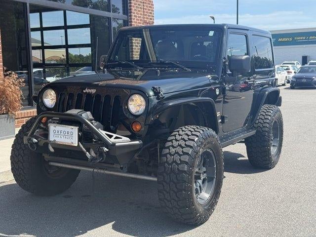 2012 Jeep Wrangler Sahara in Black Forest Green Pearlcoat — front three-quarter view